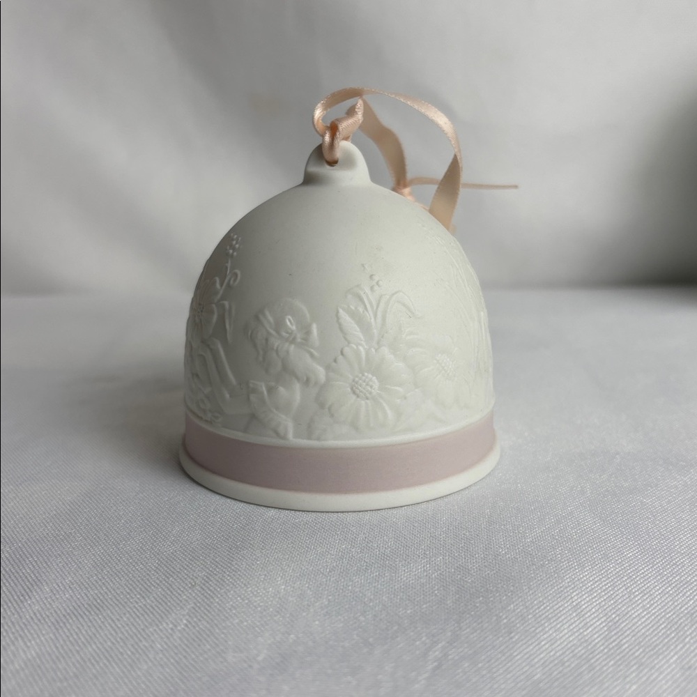 Lladro vintage 1991 ornament bell White with raised design. Pink accent.